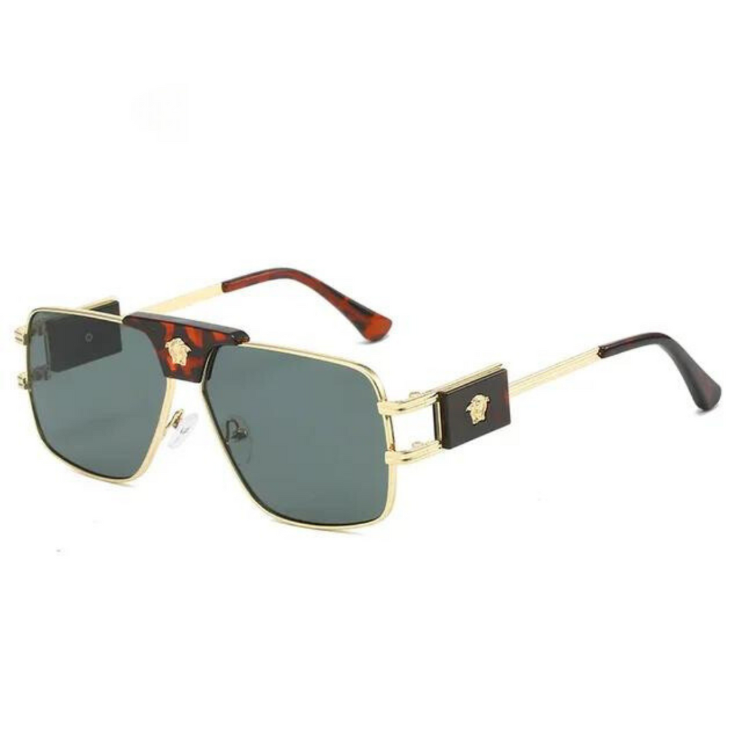 Gold-rimmed, square bold sunglasses with premium metal frames, dark lenses offering UV400 protection, tortoiseshell temple tips, and a small gold Medusa emblem on each black side piece near the hinge.