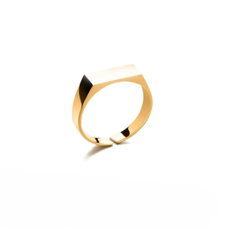 A minimalist 18K gold plated ring with a rectangular, flat top, displayed against a plain white background. The rings clean lines and modern design emphasize its geometric shape and elegant finish.