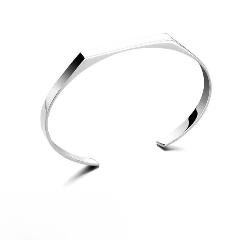 A minimalist cuff bracelet with a sleek, modern design and clean lines, crafted from stainless steel and photographed on a plain white background.
