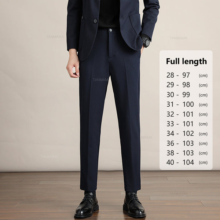A person wearing a dark suit stands on a wooden floor next to a sizing chart for Mens Slim Casual Trousers, listing pant lengths in centimeters from size 28 (97 cm) to size 40 (104 cm).