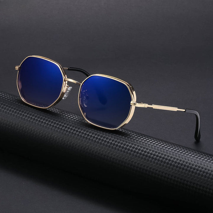 Vintage-inspired sunglasses with gold-tone frames and blue-tinted octagonal lenses rest on a black, textured surface, set against a dark background.