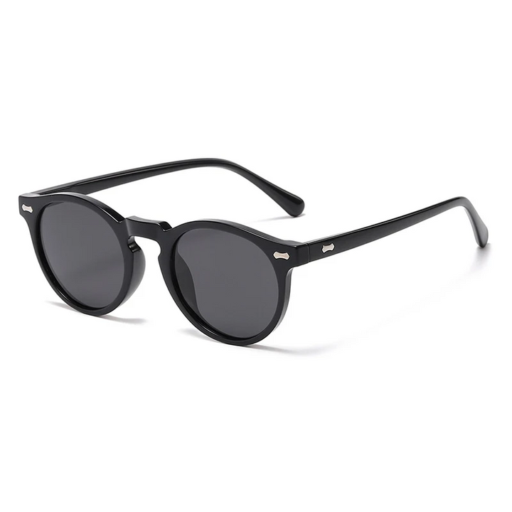 Black round frame sunglasses with dark lenses and a glossy black finish, shown at an angle on a white background. These trendsetting sunglasses offer UV400 protection for stylish, all-day comfort.