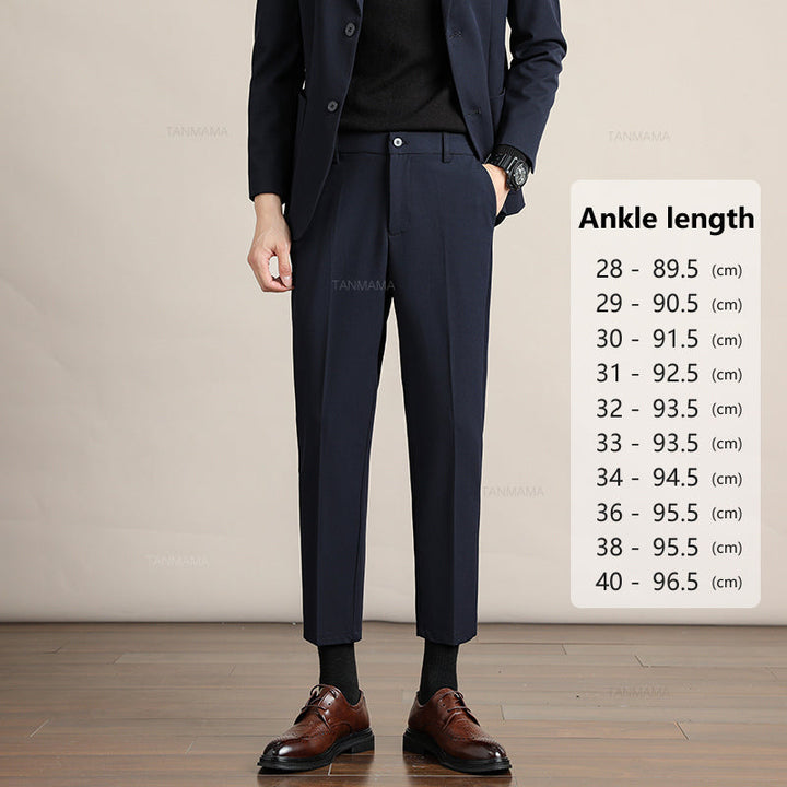 A person in a navy suit and brown dress shoes stands on a wooden floor. Next to them is a chart titled Ankle length, listing Mens Slim Casual Trousers sizes 28 to 40 with corresponding lengths in centimeters.