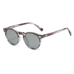 Round frame sunglasses with transparent gray frames and dark tinted lenses, offering UV400 protection, displayed on a white background at an angle showing both the front and side of the glasses.