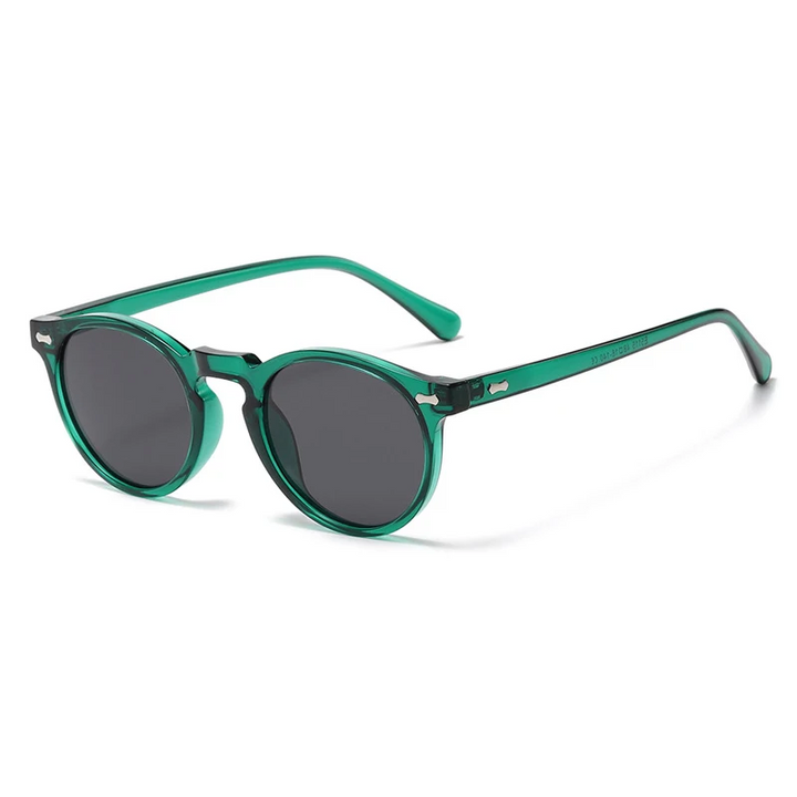 Green round-frame sunglasses with black lenses, shown at a slight angle on a white background. These trendsetting sunglasses feature a glossy finish, wide arms with small silver details near the hinges, and offer UV400 protection.