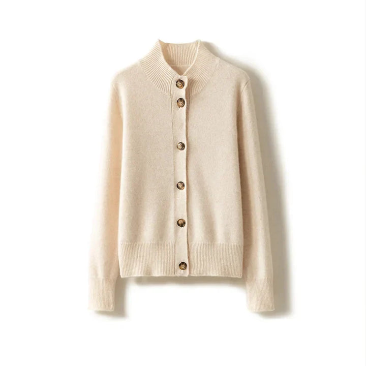 An ultra soft, cream-colored cashmere cardigan with long sleeves, brown buttons, and a ribbed collar, cuffs, and hem, displayed on a white background.