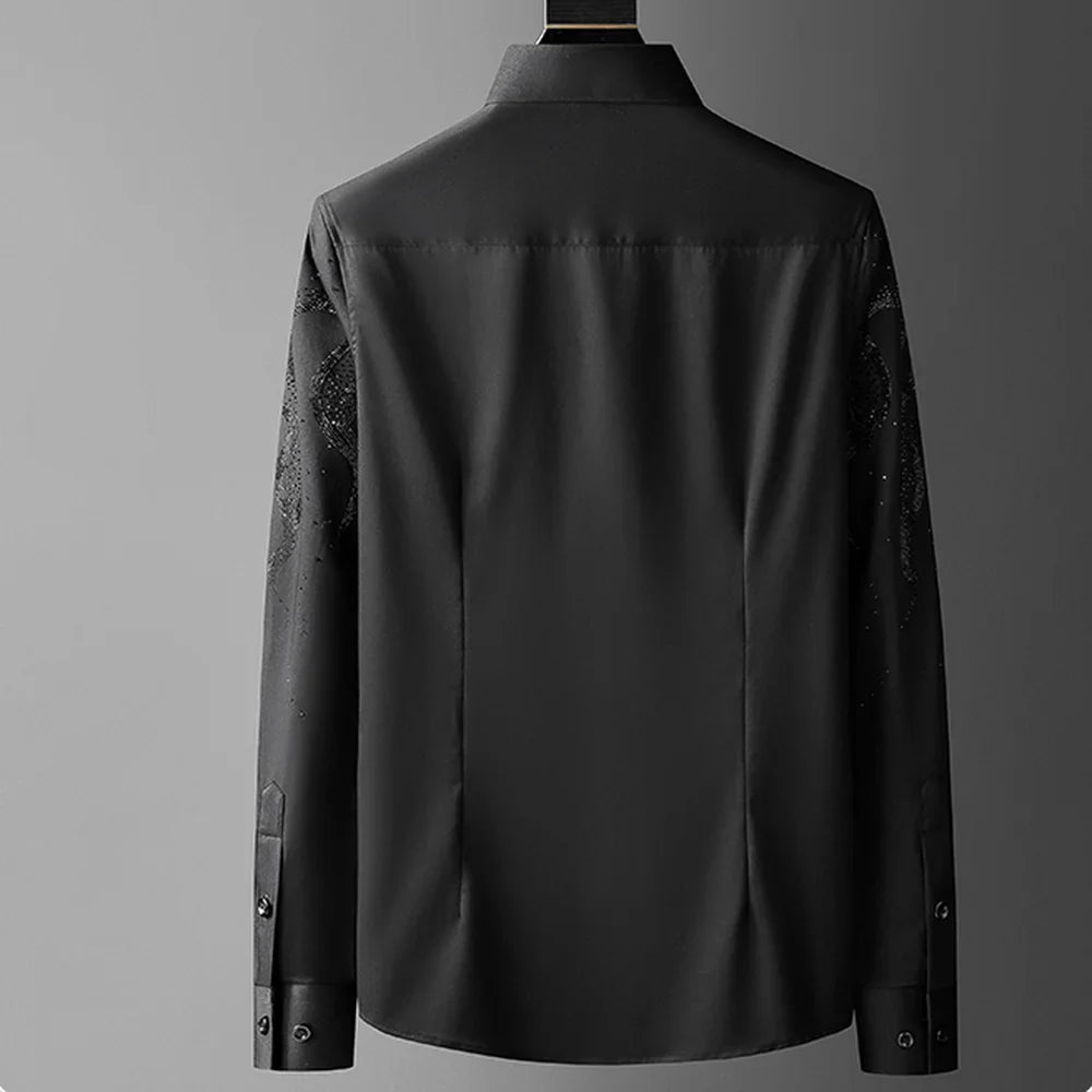 A black tailored fit button-up shirt is shown from the back against a plain gray background. The shirt features a classic collar and buttoned cuffs, with subtle patterns visible on the sleeves for added detail.