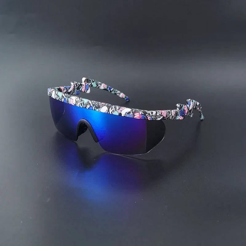 Sport sunglasses with reflective blue lenses and a curved, wraparound frame featuring a colorful abstract pattern, displayed on a smooth black surface—ideal as UV400 cycling glasses or bicycle eyewear for maximum style and protection.