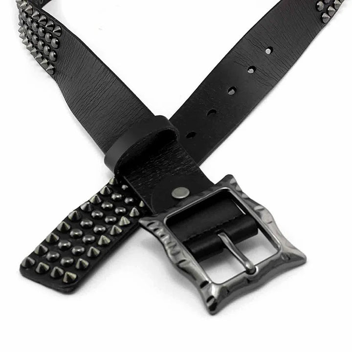 Black leather studded belt with silver pyramid-shaped studs and a textured, adjustable buckle, highlighted by its durable leather construction and striking studded detailing, displayed in a crisscross arrangement on a white background.