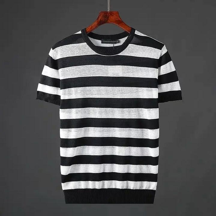 A short-sleeved knit shirt with black and white horizontal stripes, crafted from a silk cotton blend for a soft comfort-fit, displayed on a wooden hanger against a plain dark gray background.
