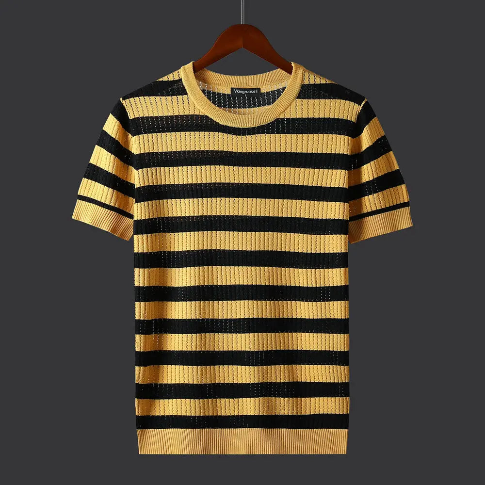 A comfort-fit short-sleeve knit sweater with horizontal black and yellow stripes hangs on a wooden hanger against a dark gray background.