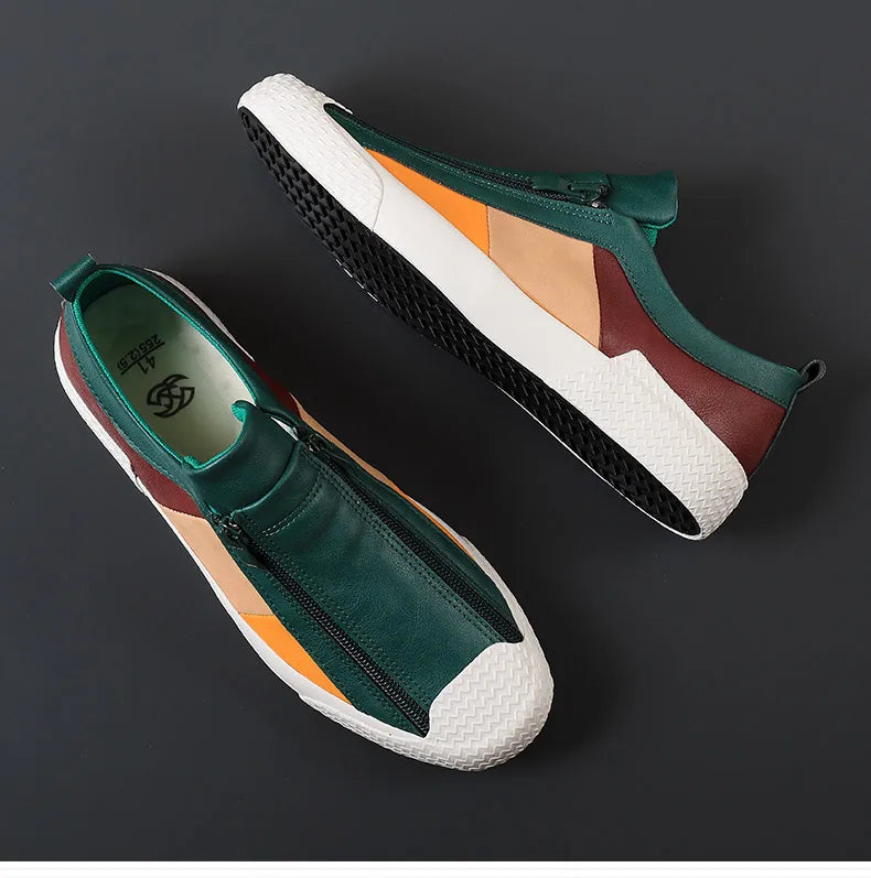 A pair of stylish sneakers with green, brown, orange, and beige panels, white textured soles, and black treads are displayed on a dark background. The shoes feature a front zipper closure and a cushioned sole for extra comfort.