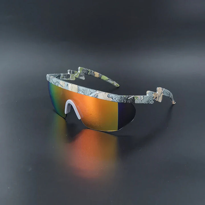 A pair of sport sunglasses with a camouflage-patterned frame and large, orange-tinted mirrored lenses, offering UV400 cycling glasses protection, displayed on a dark surface.