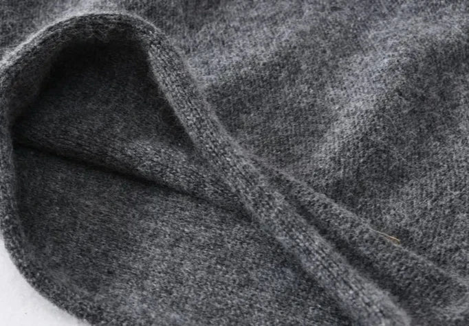 Close-up of a soft, lightweight woolen or cashmere fabric, showing its texture and slight folds, suggesting warmth and comfort—perfect for a slouchy beanie.