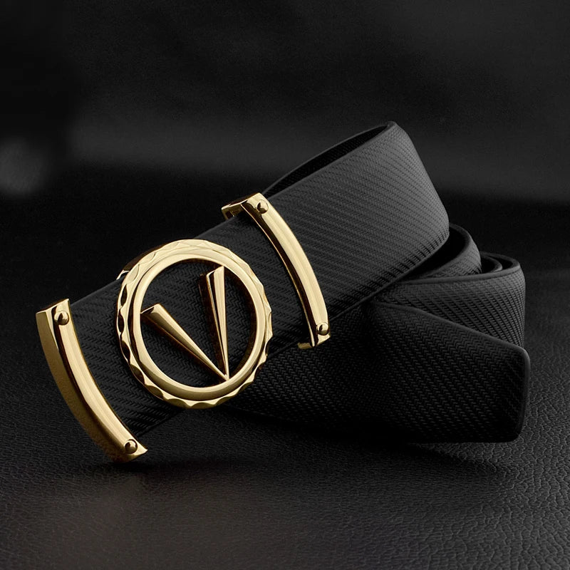 A black full-grain leather belt with a distinctive gold buckle featuring a circular design and stylized V shape, displayed on a black leather surface.