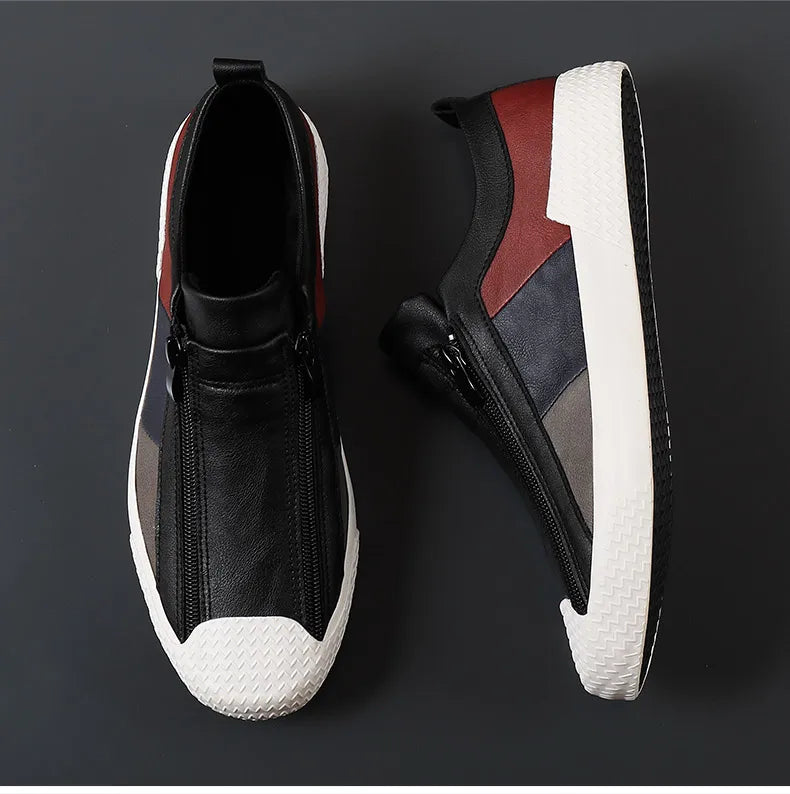 Two modern slip-on sneakers with black, gray, and burgundy panels feature a zipper closure on the front and thick white textured rubber soles for a cushioned sole feel, displayed against a dark background.