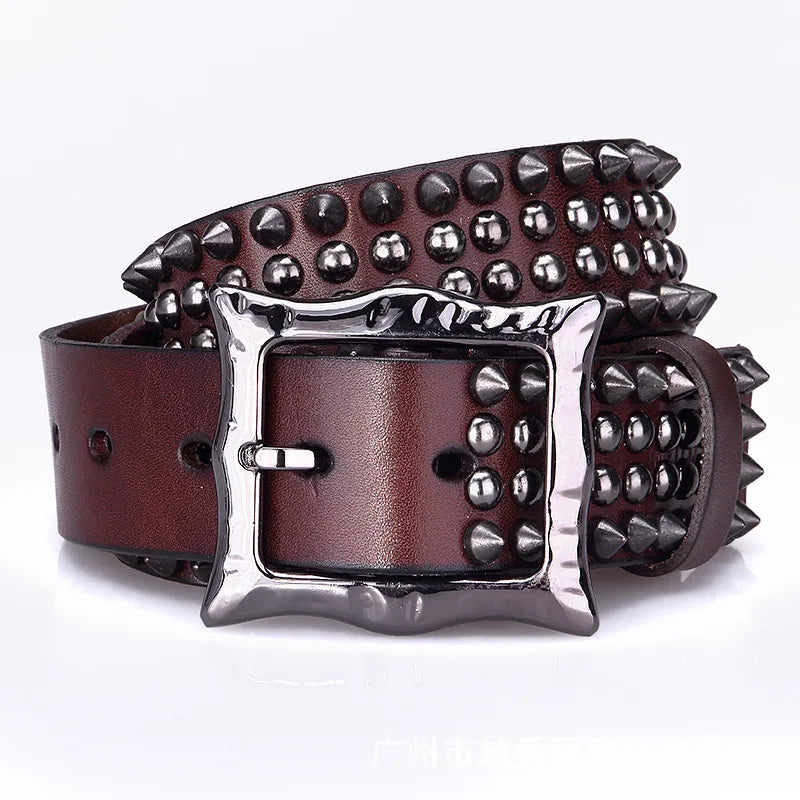 A brown leather belt with studded detailing and a shiny, square silver buckle. The belt is rolled up, showcasing its decorative buckle and premium leather construction.