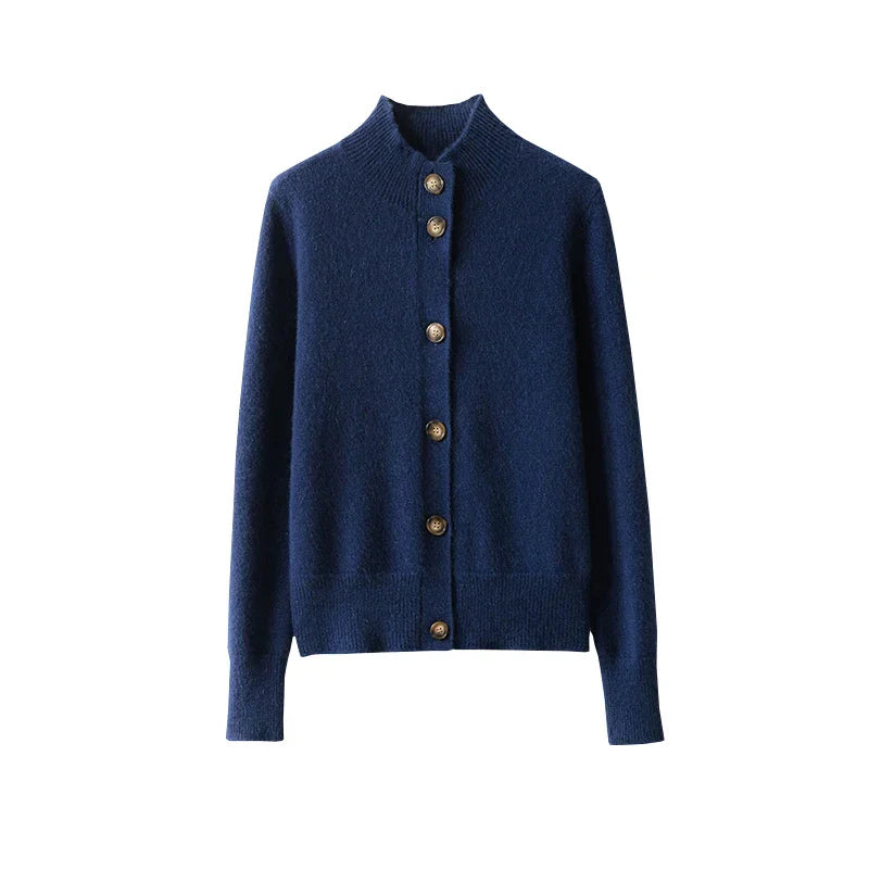 A navy blue, long-sleeve, ultra soft cashmere cardigan with a ribbed collar, cuffs, and hem, featuring a row of brown buttons down the front. The 100% wool cashmere piece is displayed on a white background.