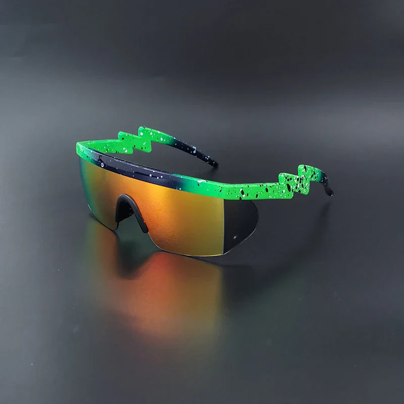 Sport sunglasses with an orange reflective lens and green, black-speckled arms are displayed on a dark, smooth surface—perfect UV400 Cycling Glasses for any ride.