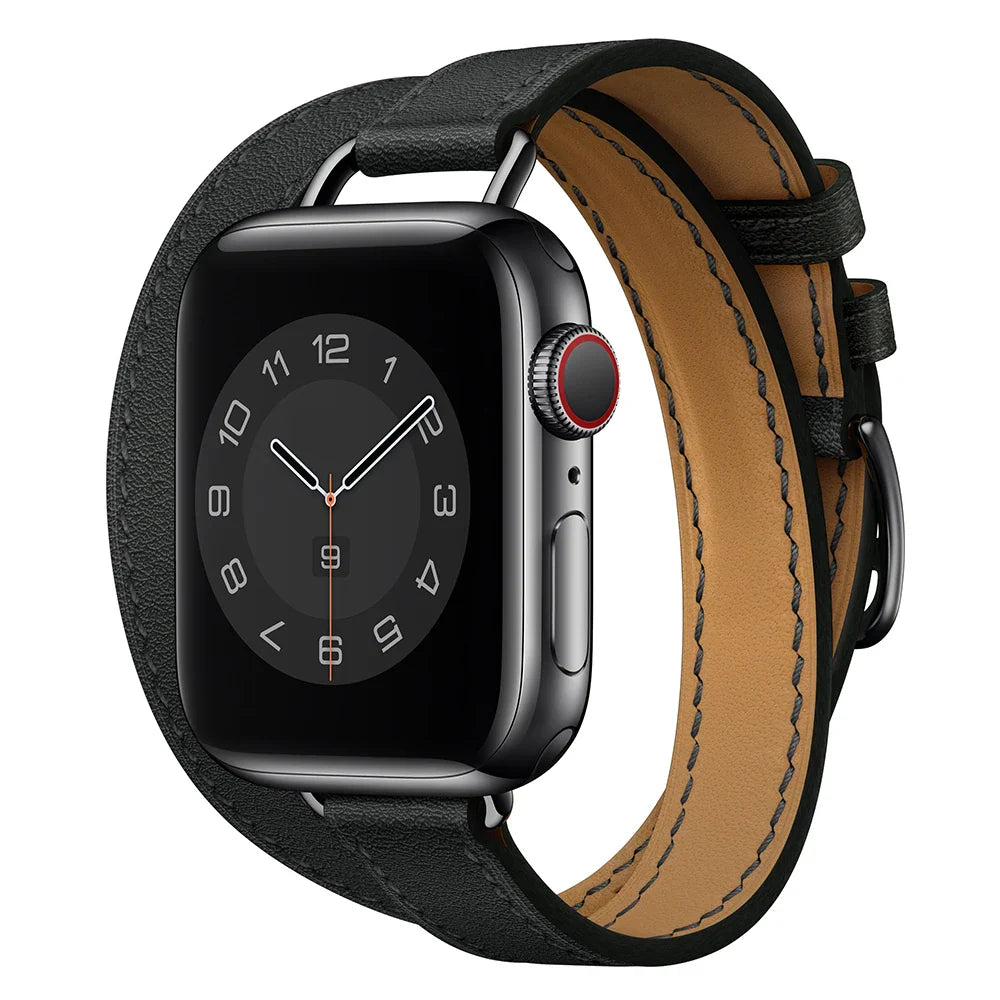 A black smartwatch with a square face displaying an analog clock, shown with a silver case and a Genuine leather Apple Watch band in a double wrap design, featuring adjustable sizing, isolated on a white background.