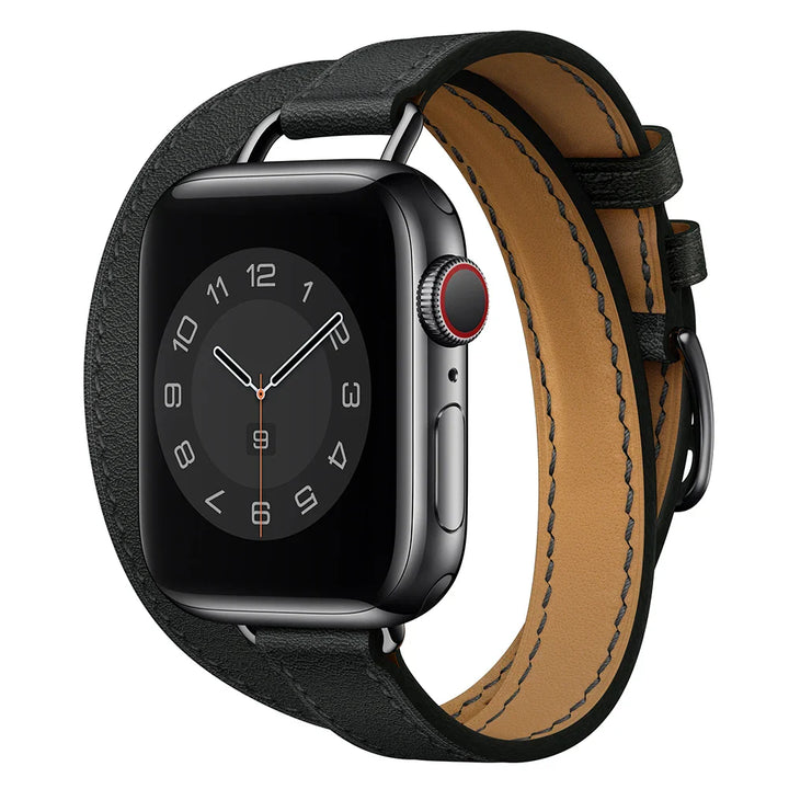 A black smartwatch with a square face displaying an analog clock, shown with a silver case and a Genuine leather Apple Watch band in a double wrap design, featuring adjustable sizing, isolated on a white background.