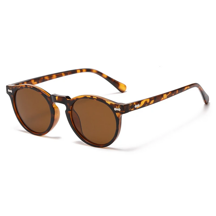 Trendsetting round frame sunglasses with a tortoiseshell finish and brown lenses, featuring UV400 protection, a classic keyhole bridge, and slightly curved arms, displayed on a white background.