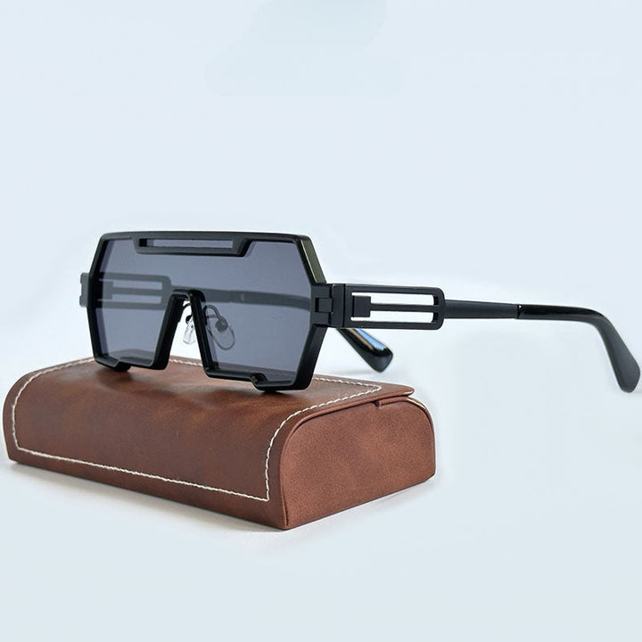 A pair of black, geometric Heavy Metal Sunglasses with dark lenses and square frames rests on a brown case with white stitching, set against a plain light background.
