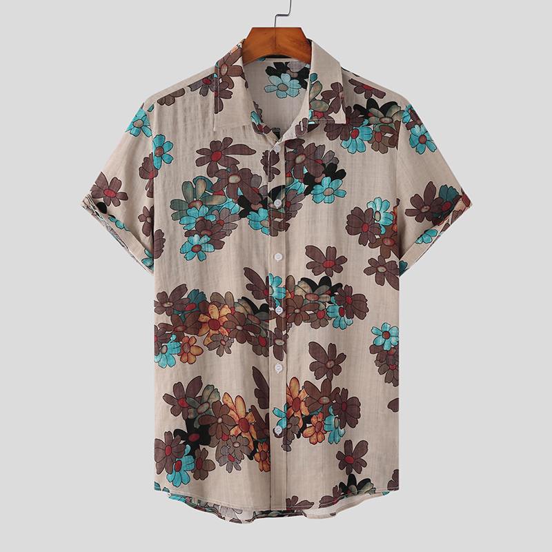A short-sleeved, beige Mens Hawaiian Shirt with a collar, featuring vibrant flower prints in brown, blue, and red hues, hanging on a wooden hanger against a plain background—a perfect pick for streetwear fashion.