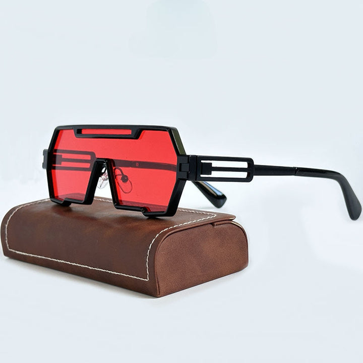 A pair of futuristic, Heavy Metal Sunglasses with bold, geometric square frames and red lenses rests on a brown leather case with white stitching, set against a light background.