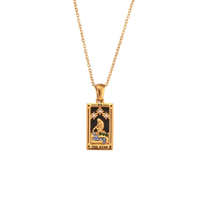 A Solaris Pendant Necklace, this 18K gold-plated chain features a rectangular tarot card pendant labeled THE STAR, adorned with blue enamel accents and colorful gemstones set against a striking black background.