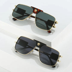 Two pairs of bold sunglasses with premium metal frames and gold emblems sit on a white surface. Their stylish rectangular design features dark lenses that offer UV400 protection for your eyes.