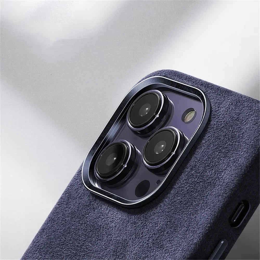 Close-up of the rear camera module of a smartphone with three lenses, shown in a dark blue textured case featuring a suede finish against a light background.