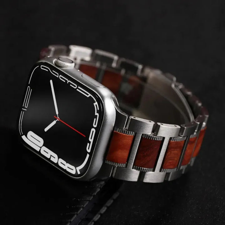 A modern smartwatch with a black screen, white digital numerals, and a red second hand, featuring a silver and sandalwood watch band, rests elegantly on a dark surface.