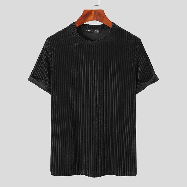 A black, short-sleeve, ribbed velvet T-shirt with a classic fit and crew neckline is shown hanging on a wooden hanger against a plain light gray background.