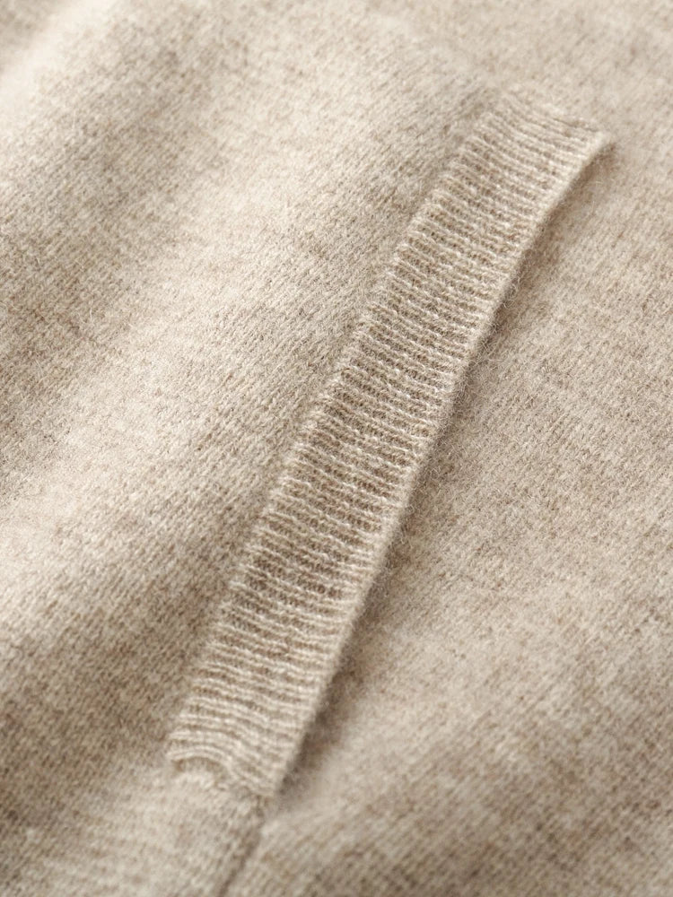 Close-up of a soft, beige knit fabric with a ribbed pocket detail. The texture appears smooth and cozy, perfect for an autumn winter cardigan or classic men wool cardigan ideal for chilly days.