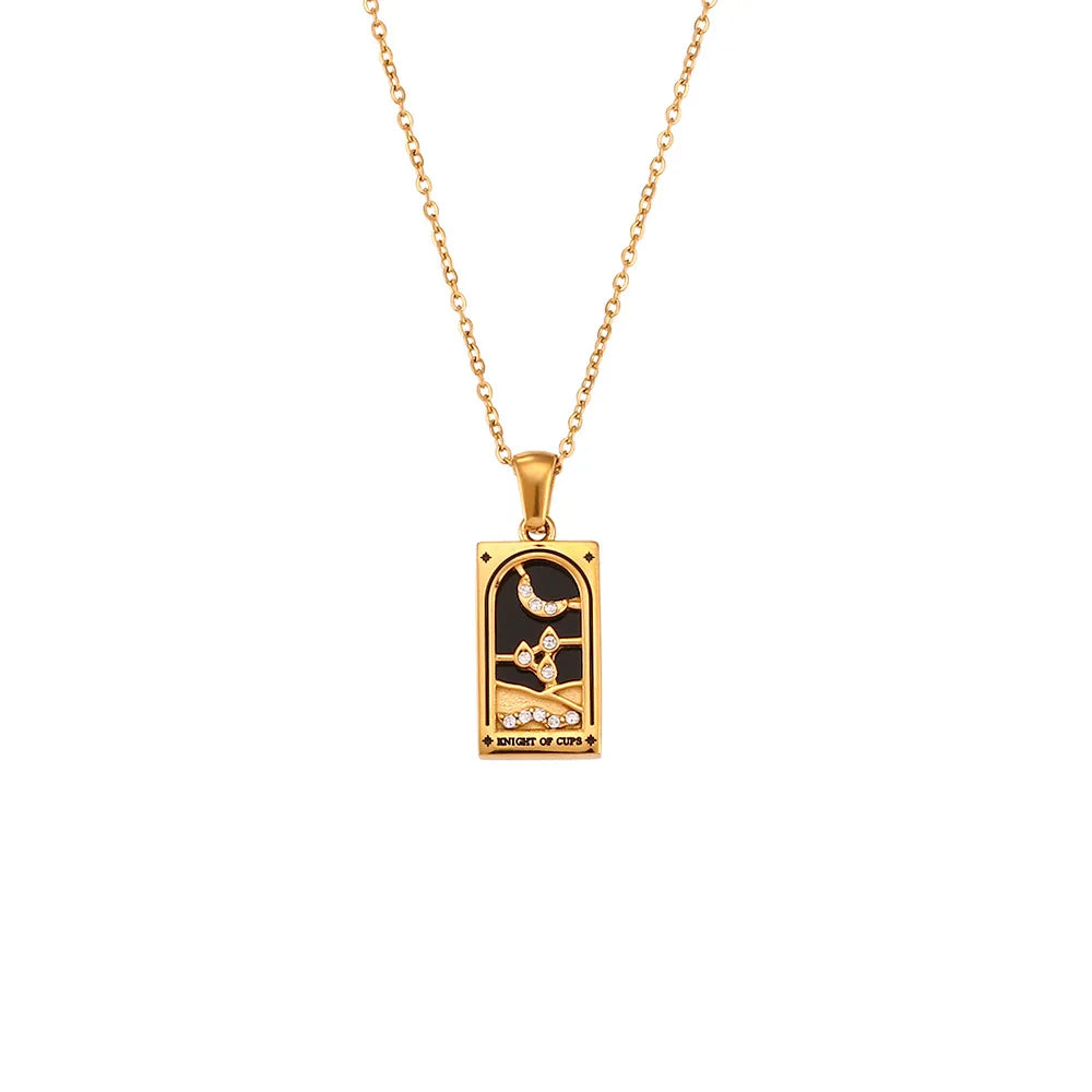 Gold chain Solaris Pendant Necklace with a rectangular 18K gold-plated pendant featuring a hand holding a cup, crescent moon, and stars on a black background, with “KNIGHT OF CUPS” inscribed at the bottom.