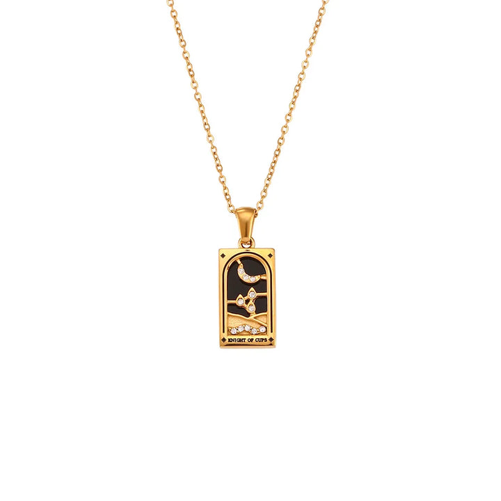 Gold chain Solaris Pendant Necklace with a rectangular 18K gold-plated pendant featuring a hand holding a cup, crescent moon, and stars on a black background, with “KNIGHT OF CUPS” inscribed at the bottom.
