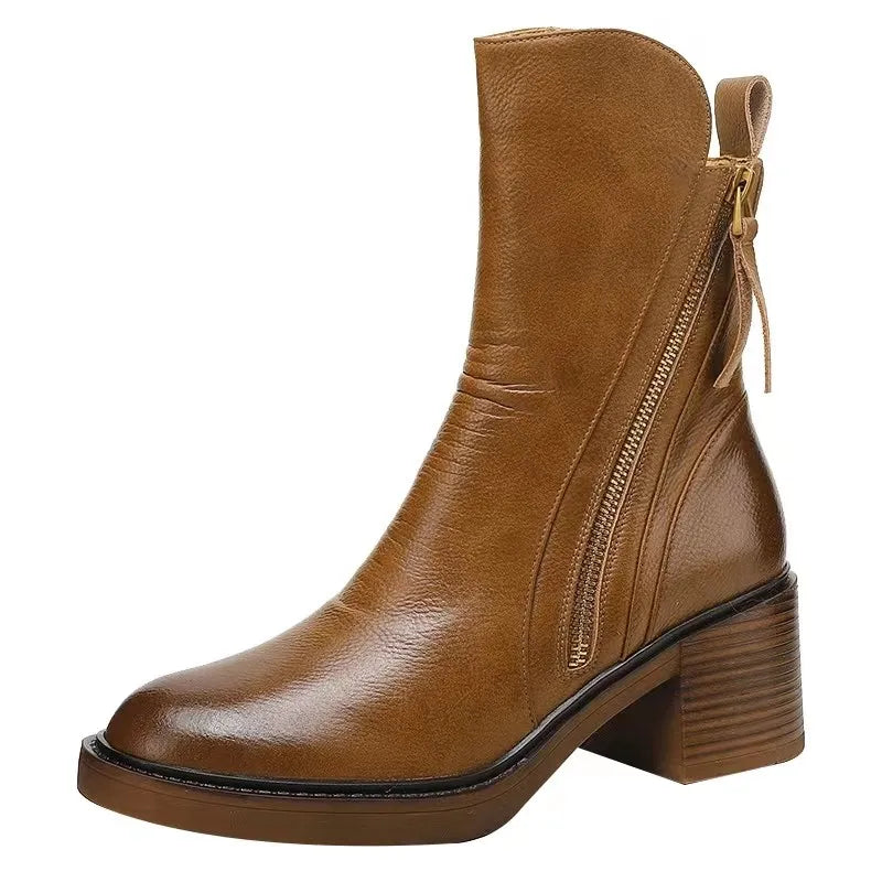 A single brown leather ankle boot, perfect as a women's winter boot, features a chunky stacked heel, side zipper, and pull tab at the back, all showcased against a white background.