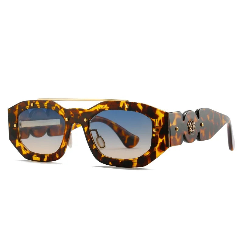 Chunky, geometric tortoiseshell sunglasses with blue gradient, scratch-resistant lenses and gold accents on the frames. The wide arms feature a decorative gold emblem, while UV400 protection keeps your eyes safe and stylish.