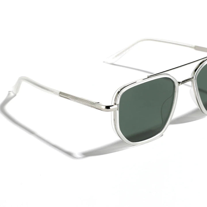 A close-up view of retro style silver metal sunglasses with dark green rectangular lenses, UV400 protection, thin frames, and clear temple tips, casting a shadow on a white surface.