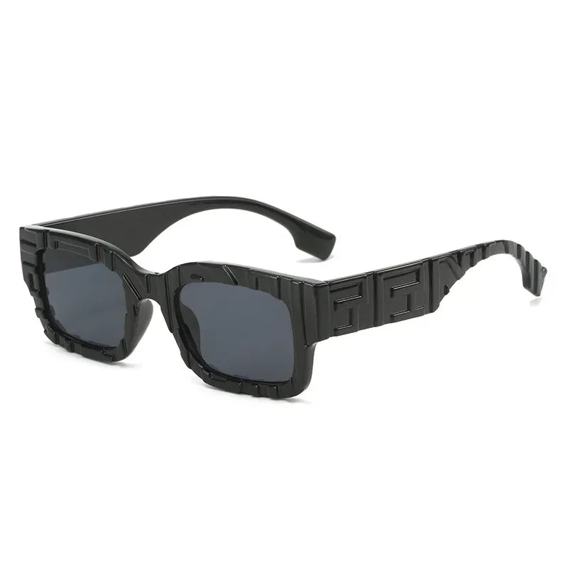 Black rectangular vintage sunglasses with thick, geometric frames featuring an embossed, textured pattern. The dark lenses offer UV400 protection and anti-glare benefits, while the arms have a wavy design in a glossy black finish.