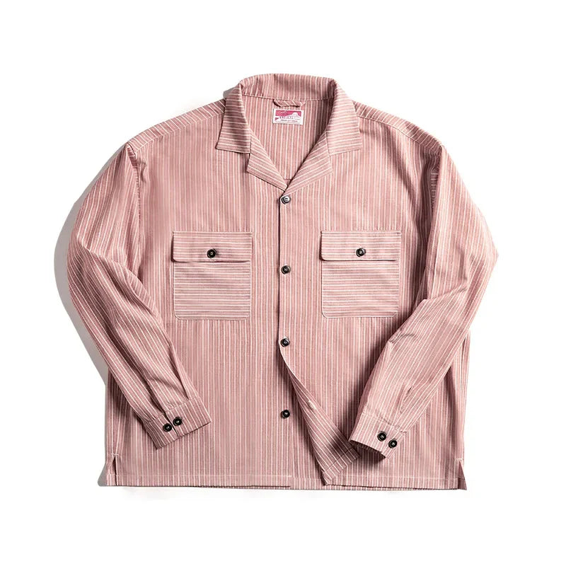 A light pink pinstripe shirt with thin white vertical stripes, two front chest pockets with flaps, black buttons, and a notched Cuban collar, crafted from high-quality cotton and laid flat on a white background.