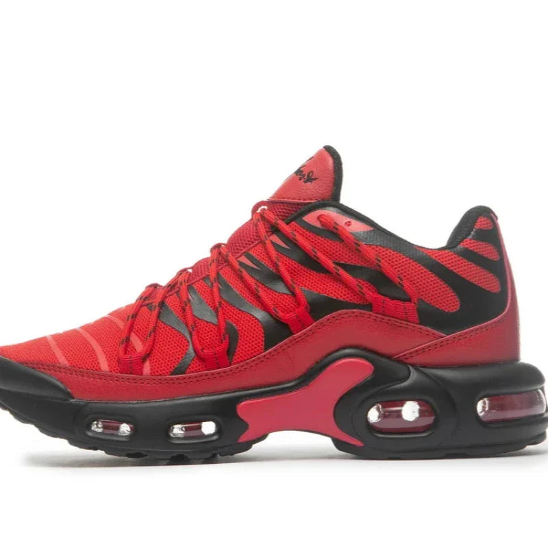A red and black athletic sneaker with a wavy black stripe design, breathable mesh upper, visible air cushioning in the sole, black laces, and a low-top style. The shoe is viewed from the side on a white background.