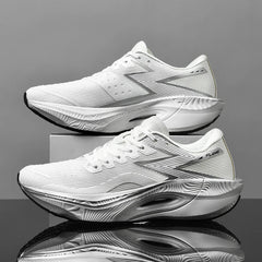 A pair of ultra-lightweight white athletic running shoes with textured soles and gray accents are displayed side-by-side against a gray background, one resting on a box and the other on a shiny black surface.