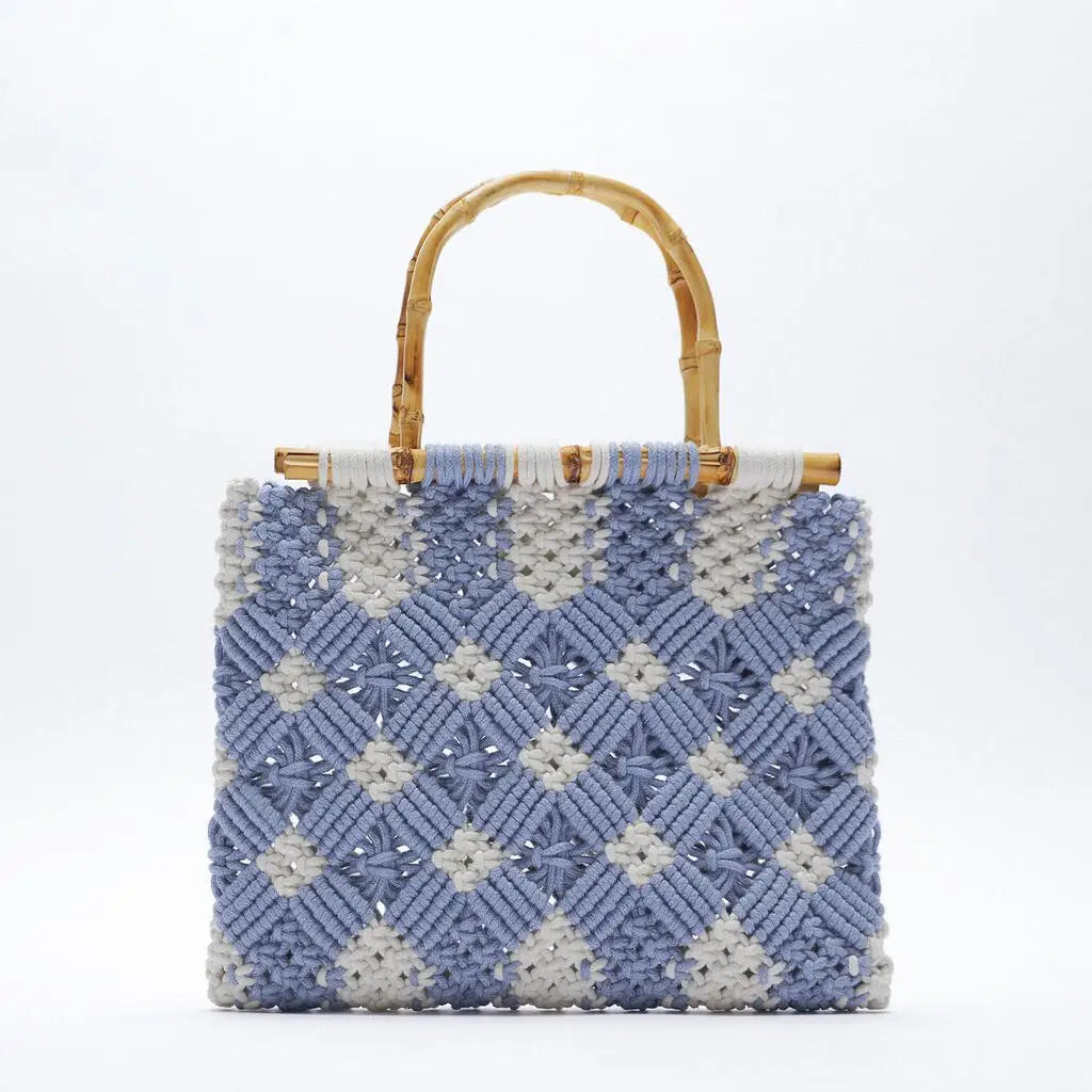A square-shaped macramé handbag with a woven blue and white diamond pattern and two curved bamboo handles, displayed against a plain white background.