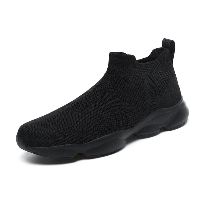 A black slip-on athletic sneaker with a lightweight, breathable knit fabric upper, thick cushioned sole, and pull tab at the heel, shown on a white background.