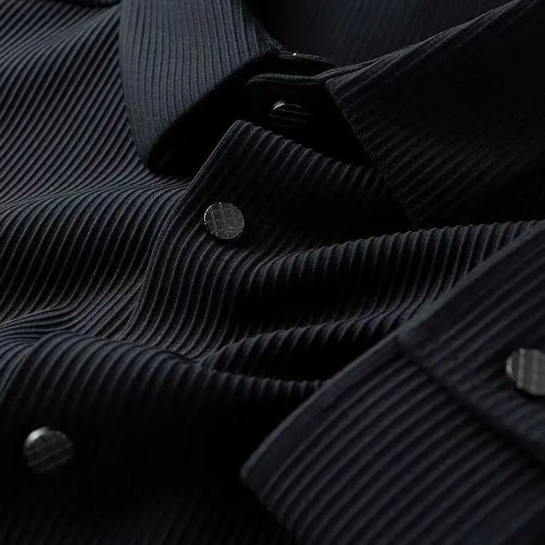 Close-up of a black, ribbed breathable shirt with a collar and metallic buttons, highlighting the ultra soft fabric’s texture and detailed stitching.