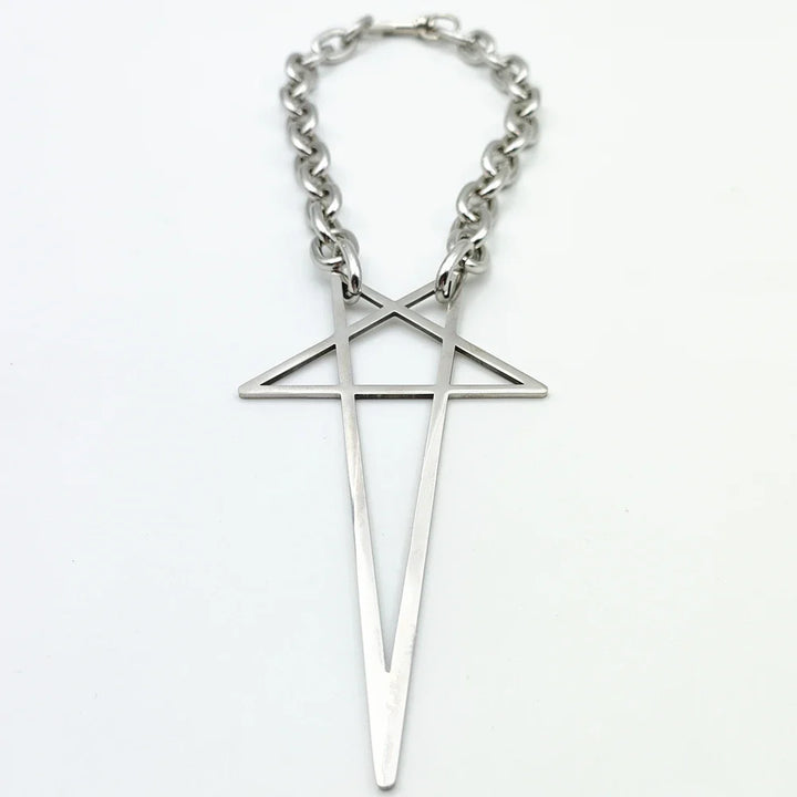 A silver stainless steel necklace features a large geometric pendant shaped like an elongated cross with an intersecting triangle near the top. Modern and minimalist, this pendant necklace makes a striking addition to streetwear jewelry collections.