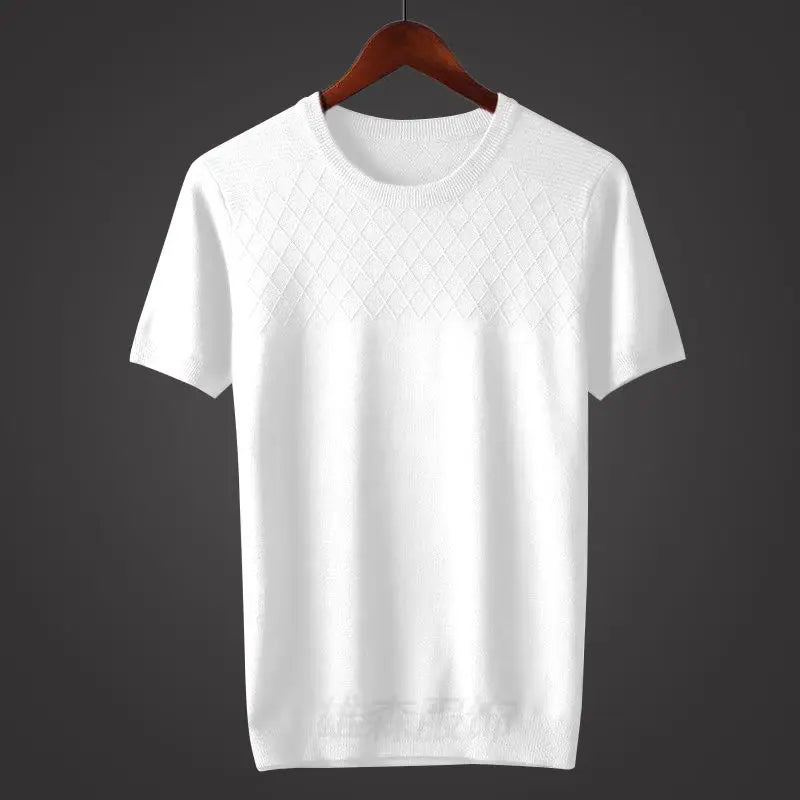 A classic fit white short-sleeve knit sweater hangs on a wooden hanger against a dark background. The upper chest area features a subtle diamond-pattern, while the rest of the sweater is smooth.
