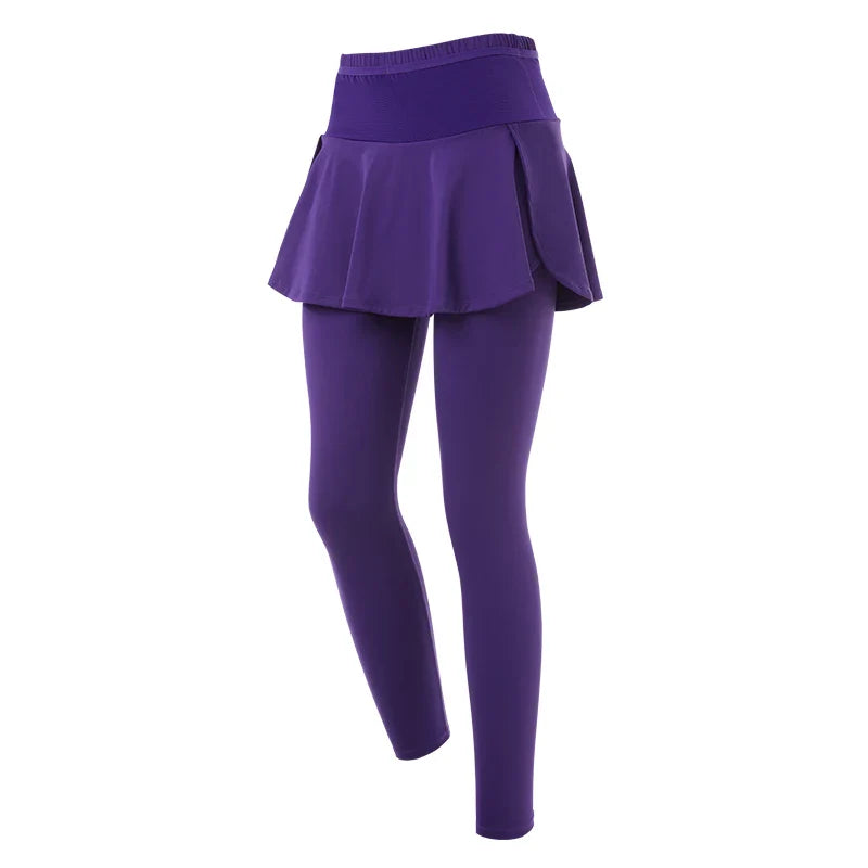 Purple skirted leggings with a flared skirt above the waistband, offering high-waisted support. Displayed on a white background, these leggings blend style and comfort for an effortlessly chic look.